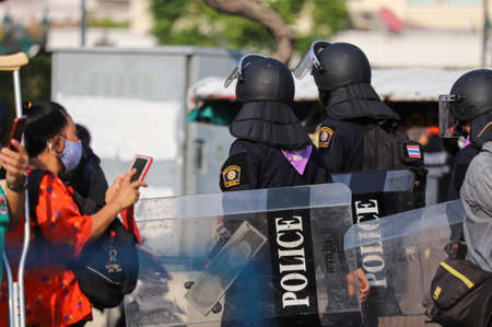 Bangkok, THAILAND - March 20, 2021: Riot police move out area the containers blocking by Thai Government for protect Restricted area from REDEM Protesters.のeditorial素材