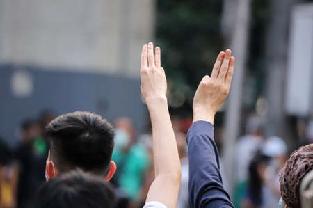 Bangkok, THAILAND - March 24, 2021: Pro-democracy protesters a three finger salute to show symbolic gestures at Ratchaprasong intersection to protests for right to bail protesters and monarchy reform.のeditorial素材