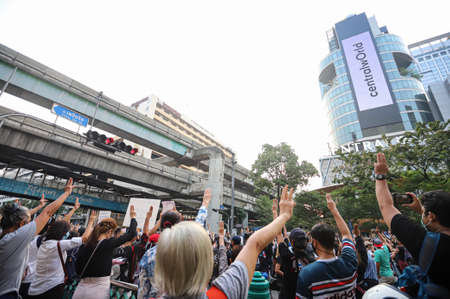 Bangkok, THAILAND - March 24, 2021: Pro-democracy protesters a three finger salute to show symbolic gestures at Ratchaprasong intersection to protests for right to bail protesters and monarchy reform.のeditorial素材