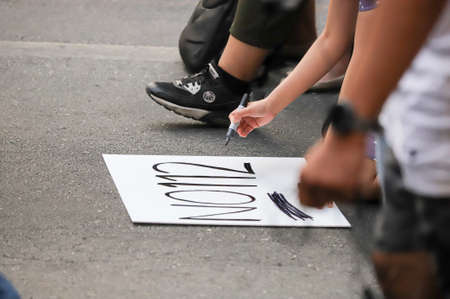 Bangkok, THAILAND - March 24, 2021: Protester write "No section 112" on sign in protests for right to bail protesters leaders and reform of the monarchy at Ratchaprasong intersection.のeditorial素材