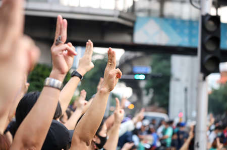 Bangkok, THAILAND - March 24, 2021: Pro-democracy protesters a three finger salute to show symbolic gestures at Ratchaprasong intersection to protests for right to bail protesters and monarchy reform.のeditorial素材
