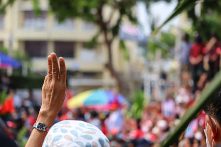Bangkok, THAILAND - April 10, 2021: UDD Red shirt a three finger salute to show symbolic gestures on commemorate the 11th anniversary of the violent crackdown on red-shirt protesters by government.のeditorial素材