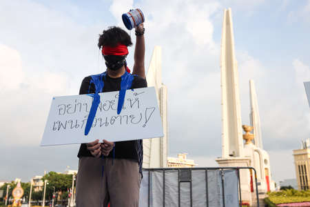 Bangkok, THAILAND - May 2, 2021: Coalition of Salaya for Democracy  stand silently 112 minute and performance art at Democracy Monument for protest the Justice and demand release of protest leaders.のeditorial素材