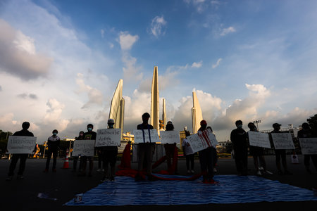 Bangkok, THAILAND - May 2, 2021: Coalition of Salaya for Democracy stand silently 112 minute and performance art at Democracy Monument for protest the Justice and demand release of protest leaders.のeditorial素材