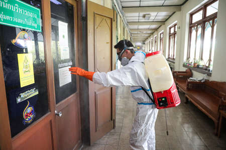 Bangkok, THAILAND - April 30, 2021: Division of Veterinary Inspection and quarantine, spray the disinfectant in the Agricultural Land Reform Office building for protect against covid-19.のeditorial素材