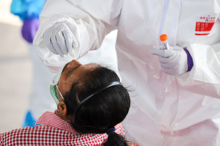 Bangkok, THAILAND - May 17, 2021: The medical worker wearing PPE to Nasal Swab Specimen for COVID-19...