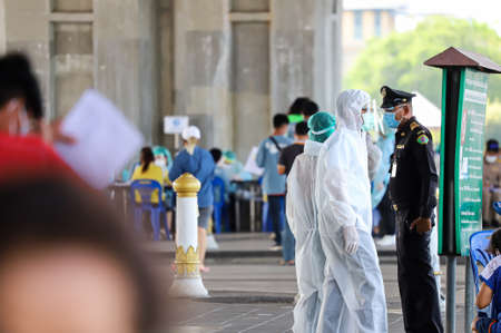 Bangkok, THAILAND - May 17, 2021: BMA City Law Enforcement Officer queue people waiting to Nasal...