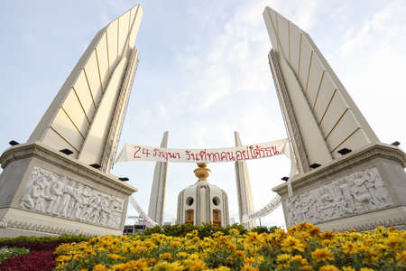 Bangkok, THAILAND - June 24, 2021: June 24, the day everyone is under the constitution, Thai text over Democracy Monument on event the memorial Siamese revolution of 1932 in the dawn.のeditorial素材