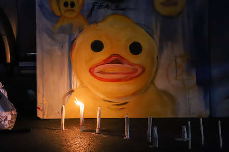 Bangkok, THAILAND - June 24, 2021: Pro-democracy protesters light a candle to memorial Siamese revolution of 1932 in the dawn at Democracy Monument.のeditorial素材