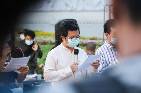 Bangkok, THAILAND - June 24, 2021: Protesters leader read the 1st Announcement of the People's Party 1932 in event the memorial Siamese revolution of 1932 in the dawn at Democracy Monument.のeditorial素材