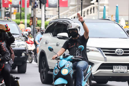 Bangkok, THAILAND - July 10, 2021: "Car Mob" Protesters a three finger salute to show symbolic gestures between driving vehicles and honk for protest and dissatisfaction the government under PM Prayut.のeditorial素材