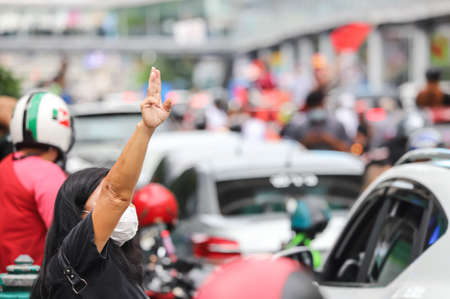Bangkok, THAILAND - July 10, 2021: "Car Mob" Protesters a three finger salute to show symbolic gestures between driving vehicles and honk for protest and dissatisfaction the government under PM Prayut.のeditorial素材