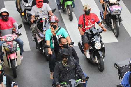 Bangkok, THAILAND - July 10, 2021: Car Mob Protesters a three finger salute to show symbolic...