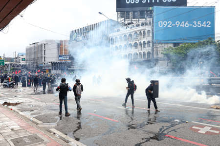 Bangkok, THAILAND - August 7, 2021: Riot police block road to 1st Infantry Regiment by container and...