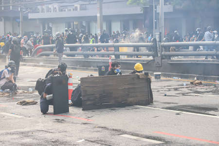 Bangkok, THAILAND - August 7, 2021: Riot police block road to 1st Infantry Regiment by container and...