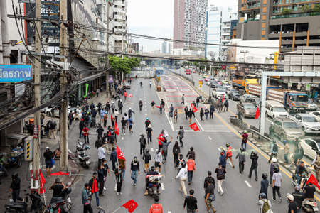 Bangkok, THAILAND - August 7, 2021: Riot police block road to 1st Infantry Regiment by container and crack down protesters by tear gas, rubber bullets, water cannon.のeditorial素材