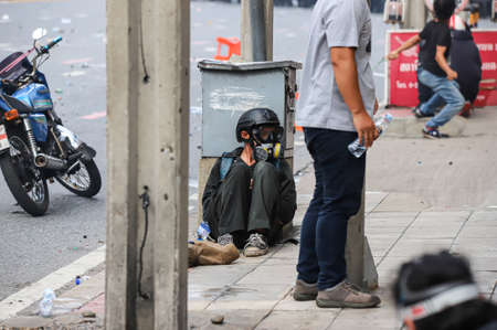 Bangkok, THAILAND - August 7, 2021: Riot police block road to 1st Infantry Regiment by container and crackdown protesters by tear gas, rubber bullets, water cannon.のeditorial素材