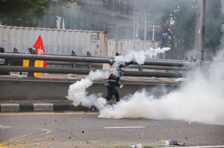 Bangkok, THAILAND - August 7, 2021: Riot police block road to 1st Infantry Regiment by container and...