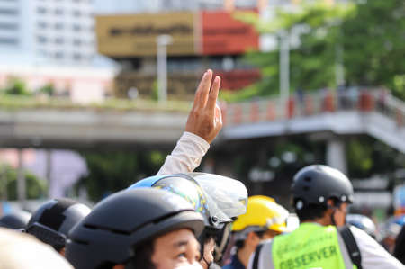 Bangkok, THAILAND - August 13, 2021: Protesters "Thalufah" a three finger salute to show symbolic gestures at Victory Monument.のeditorial素材