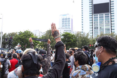 Bangkok, THAILAND - August 13, 2021: Protesters Thalufah a three finger salute to show symbolic...