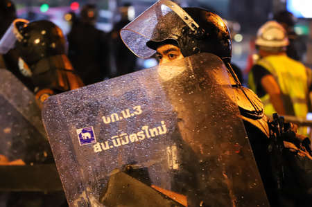 Bangkok, THAILAND - August 13, 2021: Riot police shoot tear gas and rubber bullets crackdown after protesters try to pass barrier to 1st Infantry Regiment for protest about failed covid-19 management.のeditorial素材