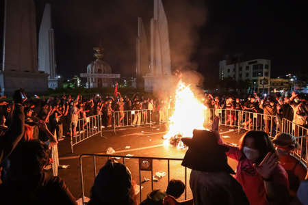 Bangkok, THAILAND - August 18, 2021: Pro-democracy protesters Thalufah burning the government straw...