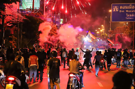 Bangkok, THAILAND - August 22, 2021: Anti-government protesters shoot the fireworks to Riot police line during clashed at Vibhavadi Rangsit Road on the way to 1st Infantry Regiment, PM Prayut house.のeditorial素材