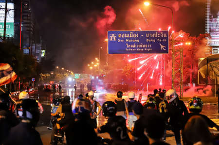 Bangkok, THAILAND - August 22, 2021: Anti-government protesters shoot the fireworks to Riot police line during clashed at Vibhavadi Rangsit Road on the way to 1st Infantry Regiment, PM Prayut house.のeditorial素材
