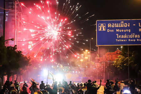 Bangkok, THAILAND - August 22, 2021: Anti-government protesters shoot the fireworks to Riot police line during clashed at Vibhavadi Rangsit Road on the way to 1st Infantry Regiment, PM Prayut house.のeditorial素材