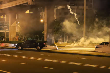 Bangkok, THAILAND - September 12, 2021: Anti-government protesters clashed Riot police at Vibhavadi Rangsit Road near Royal Thai Army Band Department on the way to 1st Infantry Regiment, PM house.のeditorial素材
