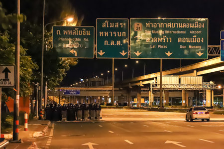 Bangkok, THAILAND - September 12, 2021: Riot police stand guard at Vibhavadi Rangsit Road near Royal Thai Army Band Department on the way to 1st Infantry Regiment, PM house.のeditorial素材