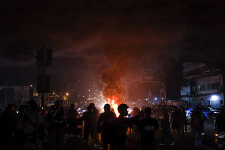 Bangkok, THAILAND - September 12, 2021: Anti-government protesters burning tire for less the riot police vision at Din Daeng Junction under Expressway bridge.のeditorial素材