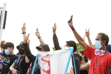 Bangkok, THAILAND - August 22, 2021: Protesters a three finger salute to show symbolic gestures...