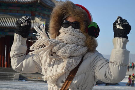 A woman playing with snow ballの写真素材