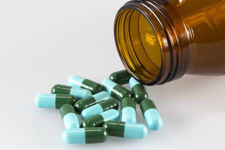 pot of green and blue capsule pillsの写真素材