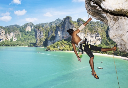 Adult climbing hard overhanging wall in Krabi, Thailand  の写真素材