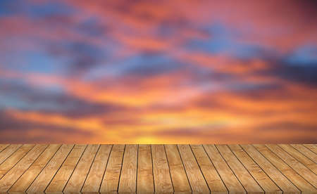 Wood table top on blurred red background - can be used for montage or display your productsの写真素材
