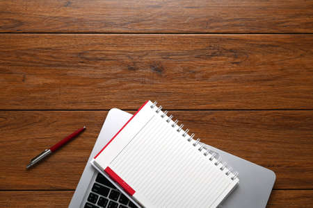 Flat lay, Close up Clean Open Notebook, phone, paper, Tablet, on Top of Wooden Table with Copy Space...