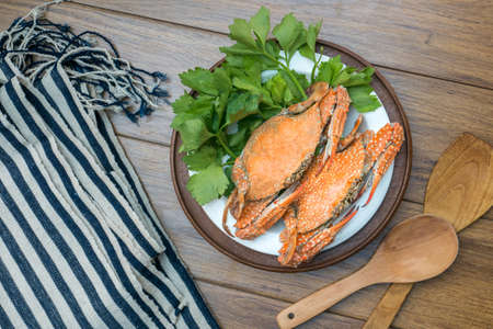 Steamed Blue Crabs  and garnished on a wooden tableの写真素材