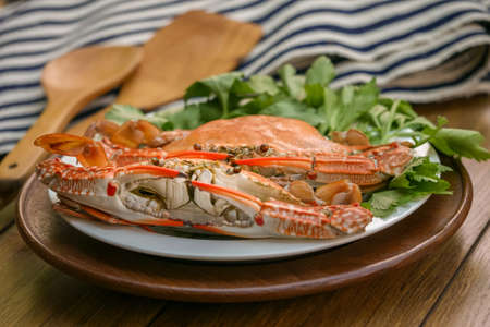 Steamed Blue Crabs  and garnished on a wooden tableの写真素材