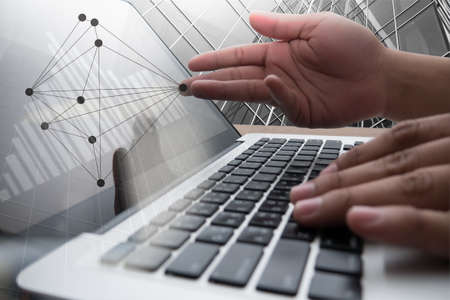 Close up of business man hand working on blank screen laptop computer on wooden desk as concept with...