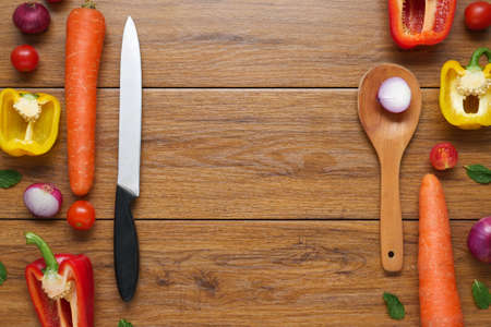 Colorful organic vegetables with wooden spoon , ingredients for salad or filling on rustic wooden background, top view. Healthy food or diet cooking concept, Vegetarian or diet foodの写真素材