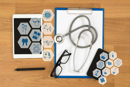 Medical equipment: gray stethoscope and tablet ,desktop top view, interface as medical conceptの写真素材