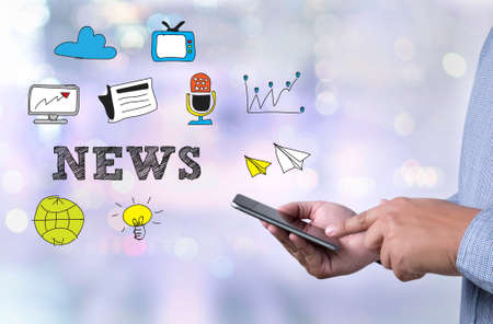 person holding a smartphone on blurred cityscape backgroundの写真素材