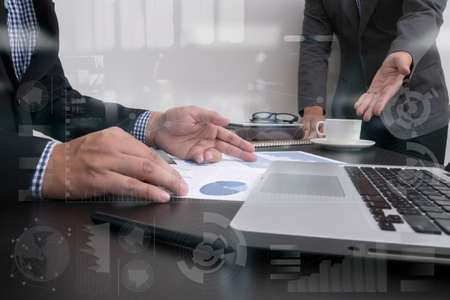 business documents on office table with smart phone and laptop computer and graph business with...