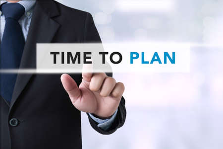 Time to Plan concept , Businessman touching a touch screen on blurred city backgroundの写真素材