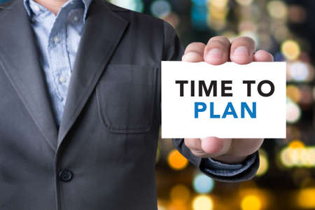 Time to Plan concept, Businessman message on the card shown on blurred city background,の写真素材