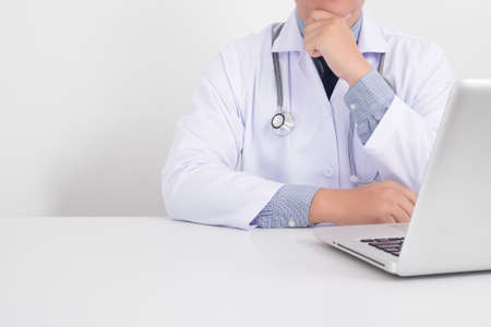 Portrait of a male handsome doctor thinkingの写真素材
