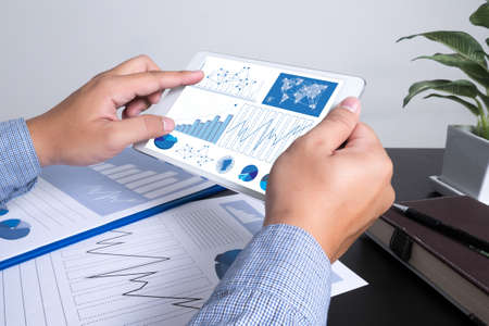 Marketing data in digital tablet and male hand over itの写真素材