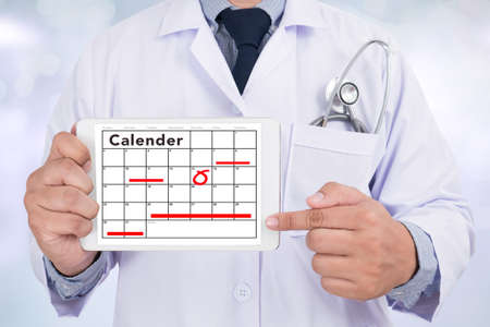 Doctor holding tablet computer with Calender Remind HEALTH CHECK Conceptの写真素材